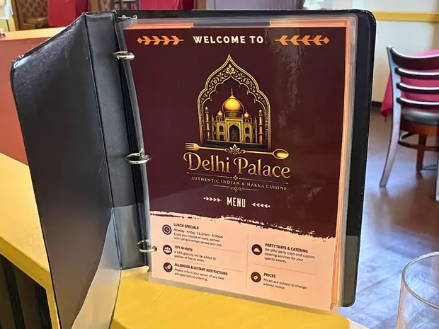 The welcome menu binder standing on a table inside Delhi Palace