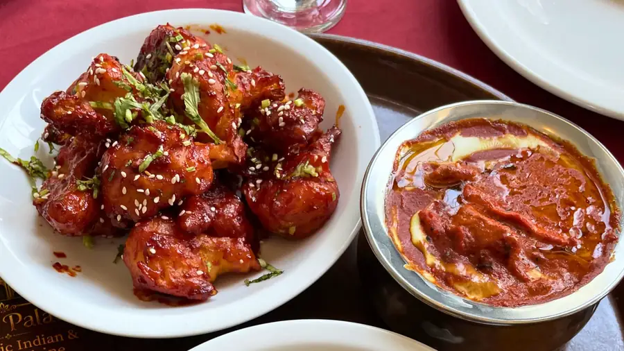 Chilli chicken and a bowl of butter chicken photographed close up
