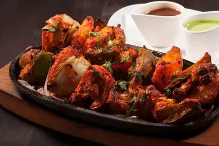 Tandoori non vegetarian appetizers on a sizzling platter