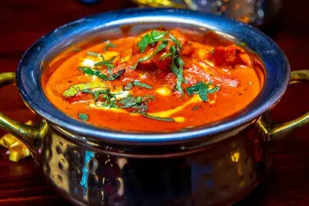 Indian non vegetarian curry in a copper handi