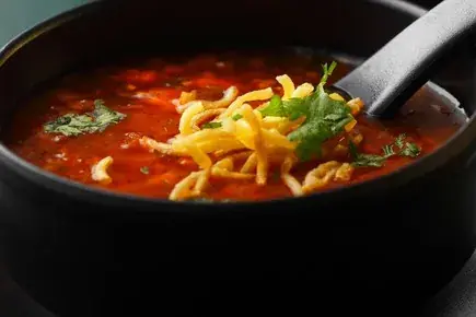 Hot and sour soup in a black bowl